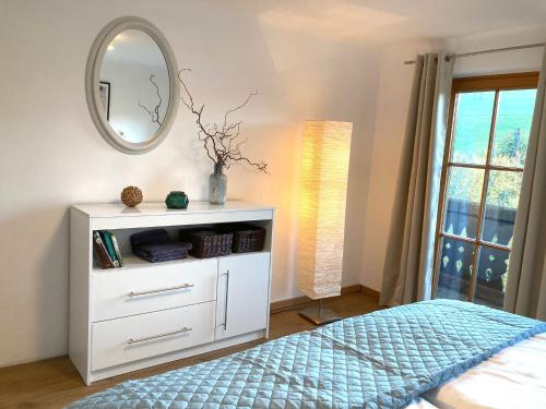 a bedroom with a white dresser and a mirror at Appartement Linde in Mürzzuschlag