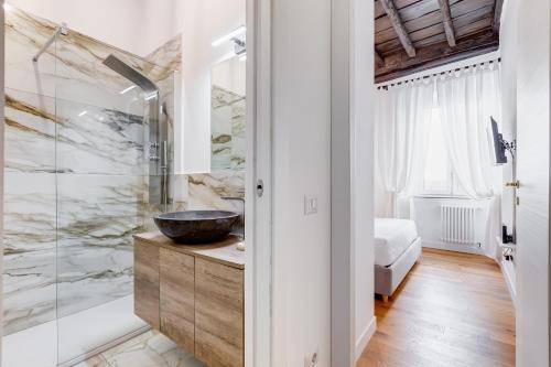 a bathroom with a sink and a glass shower at Boschetto 118 in Rome