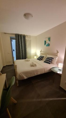 a bedroom with a large bed and a window at LITHOS ROOMs in Matera