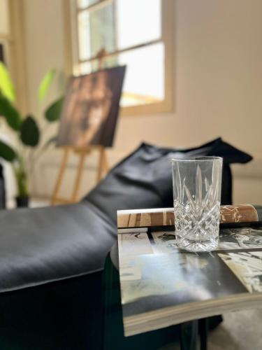 a glass sitting on a table next to a couch at The Old Town Heritage House Platform 357 in Nicosia