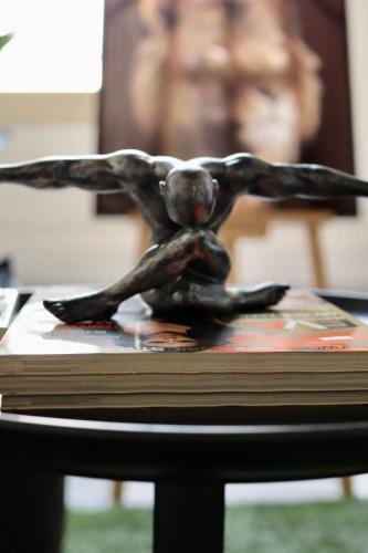 a statue of a woman sitting on top of a book at The Old Town Heritage House Platform 357 in Nicosia