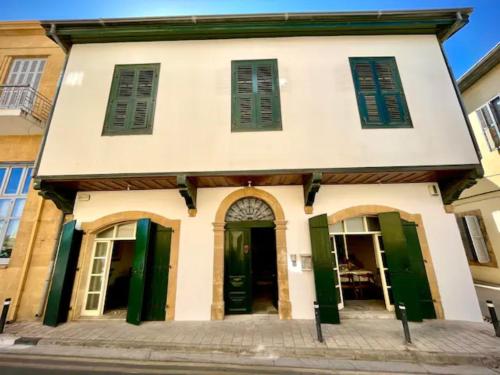 an old building with green doors on a street at The Old Town Heritage House Platform 357 in Nicosia