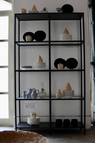 a shelf filled with dishes and bowls and plates at The Old Town Heritage House Platform 357 in Nicosia
