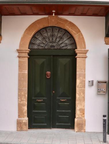 a green door in a building with an arch at The Old Town Heritage House Platform 357 in Nicosia
