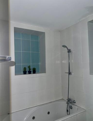 a white bathroom with a tub and a window at The Old Town Heritage House Platform 357 in Nicosia