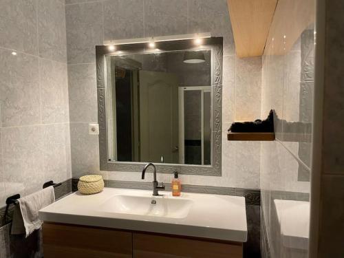 y baño con lavabo y espejo. en Fantastic NEW 120m2 Beach House in El Palo Malaga, en Málaga