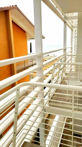a staircase in a building with white rails at Hotel Strand a frontemare in Lido di Jesolo