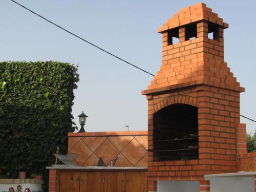 a brick building with a clock on top of it at Good Feeling Hostel & Guest House in Raposeira