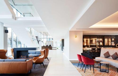 a lobby of a hotel with chairs and a fireplace at Hyatt Regency Manchester in Manchester