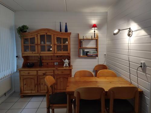a dining room with a wooden table and chairs at AMPEL Bed by the Sea in Westkapelle
