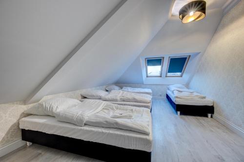a room with two beds in a attic at Dworek Kurowski in Szczecin