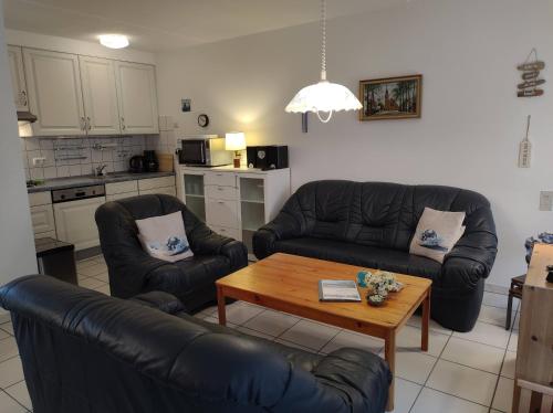 a living room with two couches and a coffee table at AMPEL Bed by the Sea in Westkapelle