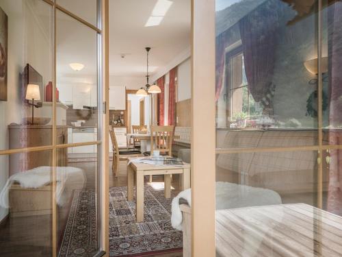 a room with a glass door and a table at Hotel Garni Larcherhof in Mayrhofen