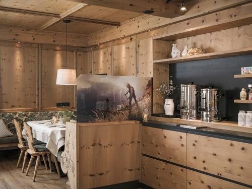 a dining room with wooden cabinets and a table at Hotel Garni Larcherhof in Mayrhofen