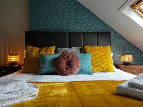 a bedroom with a large bed with colorful pillows at Woodquay House in Galway
