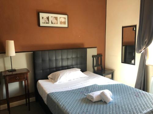 a bedroom with a bed with two towels on it at Hotel Casale dei Massimi in Rome