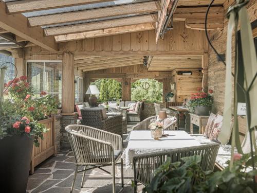 an outdoor patio with a table and chairs at Hotel Garni Larcherhof in Mayrhofen