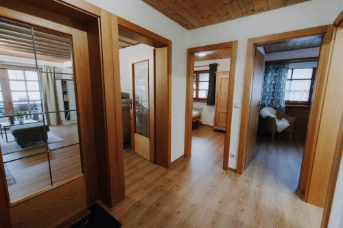 a living room with wooden floors and glass doors at Alpenflair Ferienwohnung 317 Alpengrün in Oberstdorf