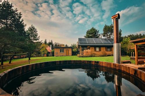 a pool in the backyard of a home with a house at Winiec Family Houses in Winiec