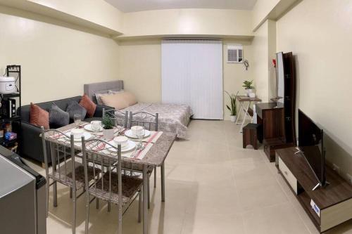 a living room with a couch and a table in a room at Condo Unit near Ayala Serin Mall in Tagaytay