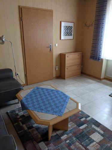 a living room with a coffee table in front of a door at Ferienwohnung Bruss in Saarlouis