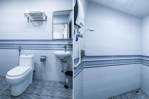 a bathroom with a toilet and a sink at SP Star Hotel in Sungai Petani