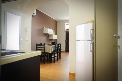 a kitchen and dining room with a table and a refrigerator at La casa di Bice in Cassibile