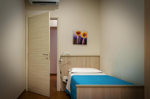 a hospital room with a bed and a painting on the wall at La casa di Bice in Cassibile