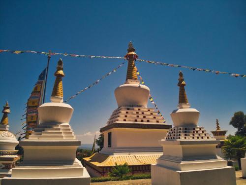 a group of white pagodas with prayer flags at SidroAndCo Rural Home in Secastilla