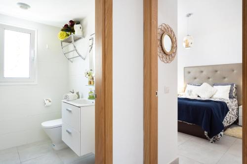 a bathroom with a bed and a toilet and a sink at River Suite El Galeón in Adeje
