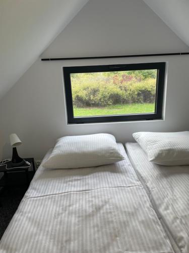 a bedroom with two beds and a window at Apartamenty Medyka Park in Medyka