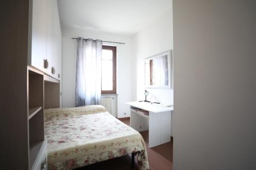 a small bedroom with a bed and a sink at Casa Dolce Casa in Casorate Primo