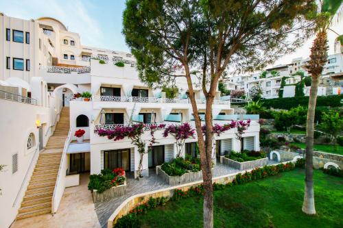 an exterior view of a building with flowers at Azka Hotel in Bodrum City