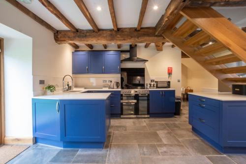 a kitchen with blue cabinets and blue counters at The Hophouse in Hereford