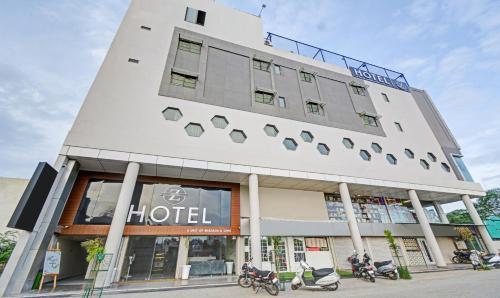 a hotel with motorcycles parked in front of it at Treebo Trend Z in Bhilwara