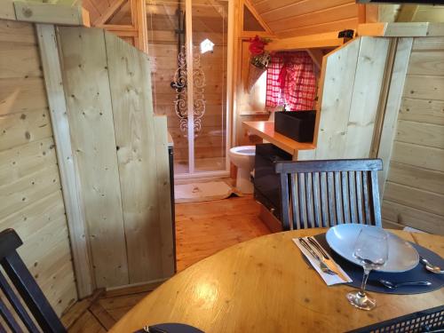 a wooden table with a plate on it in a cabin at Au Doubs Kota 