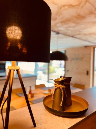 a pair of boots sitting on a table next to a lamp at FourElements in Wernigerode