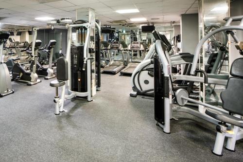 a gym with lots of treadmills and machines at Mercure Bolton Georgian House Hotel in Bolton