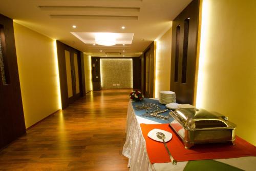 a room with a table with plates on it at Calangute Towers - AM Hotel Kollection in Calangute