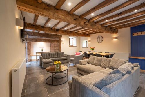 a large living room with couches and a table at The Hophouse in Hereford