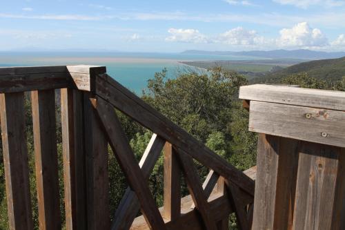 a wooden balcony with a view of the ocean at Tenuta Agricola dell'Uccellina in Talamone