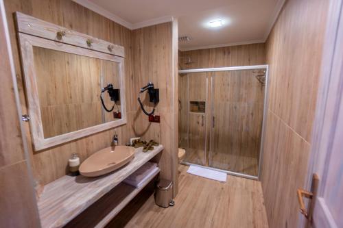 a bathroom with a sink and a shower at Azka Hotel in Bodrum City