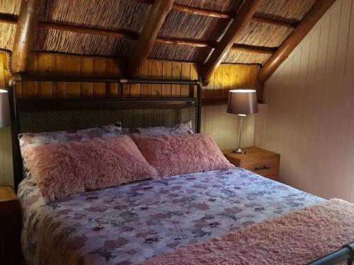 a bedroom with a bed and a wooden ceiling at SHABBY FUFU LIFESTYLE FARM in Plettenberg Bay