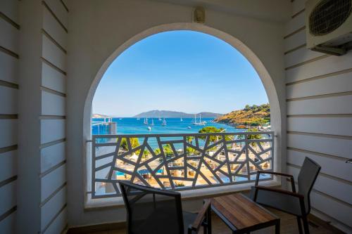 a room with a view of the ocean from a balcony at Azka Hotel in Bodrum City