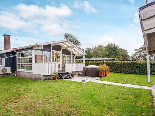 a house with a lot of windows and a yard at 7 person holiday home in Juelsminde-By Traum in Juelsminde