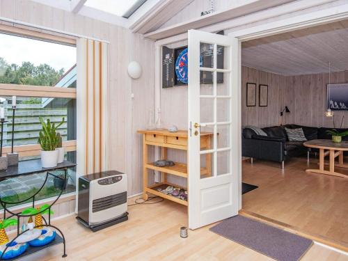 a room with a door open to a living room at 7 person holiday home in Juelsminde-By Traum in Juelsminde