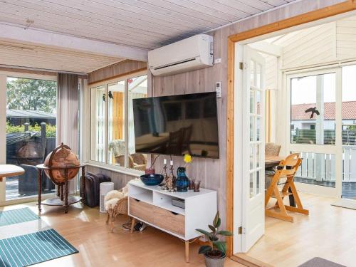 a living room with a flat screen tv on a wall at 7 person holiday home in Juelsminde-By Traum in Juelsminde