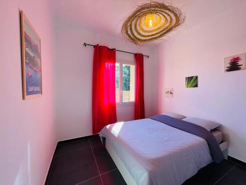 サン・ラファエルにあるFloramarineのベッドルーム1室(ベッド1台付)、赤いカーテン付きの窓が備わります。