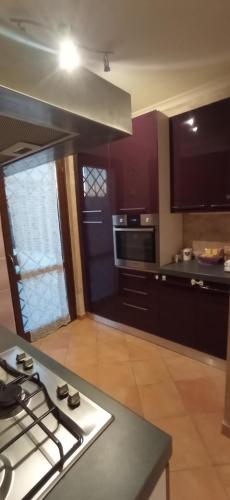 a kitchen with a stove and a counter top at Da Vinci House in Fiumicino