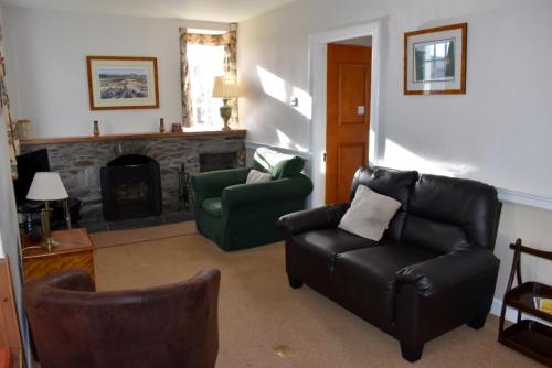 a living room with a couch and a fireplace at Castle Peroch in Dunkeld